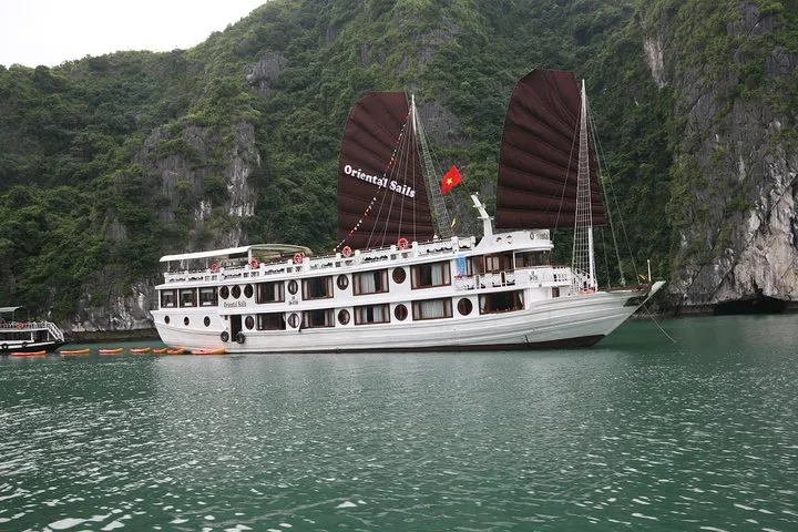 Traditional-style wooden junk with sails on an overnight Ha Long Bay junk boat cruise, Vietnam