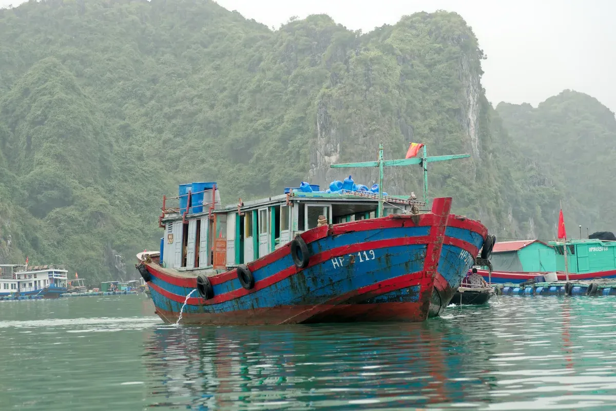 Fishing boat moored near Cai Beo floating village in Lan Ha Bay, Halong Bay cruise