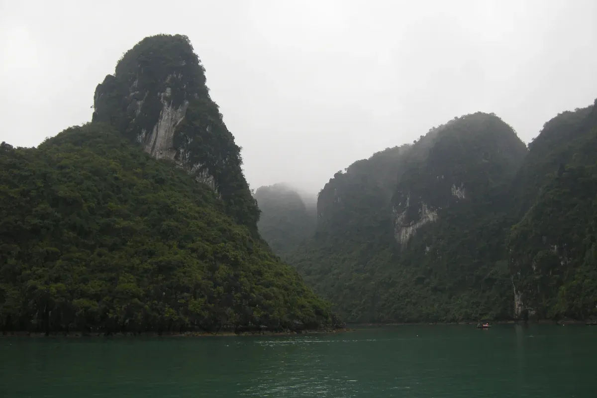 Tower karsts wrapped in fog on Ha Long Bay, a typical misty day for a Ha Long Bay junk boat cruise