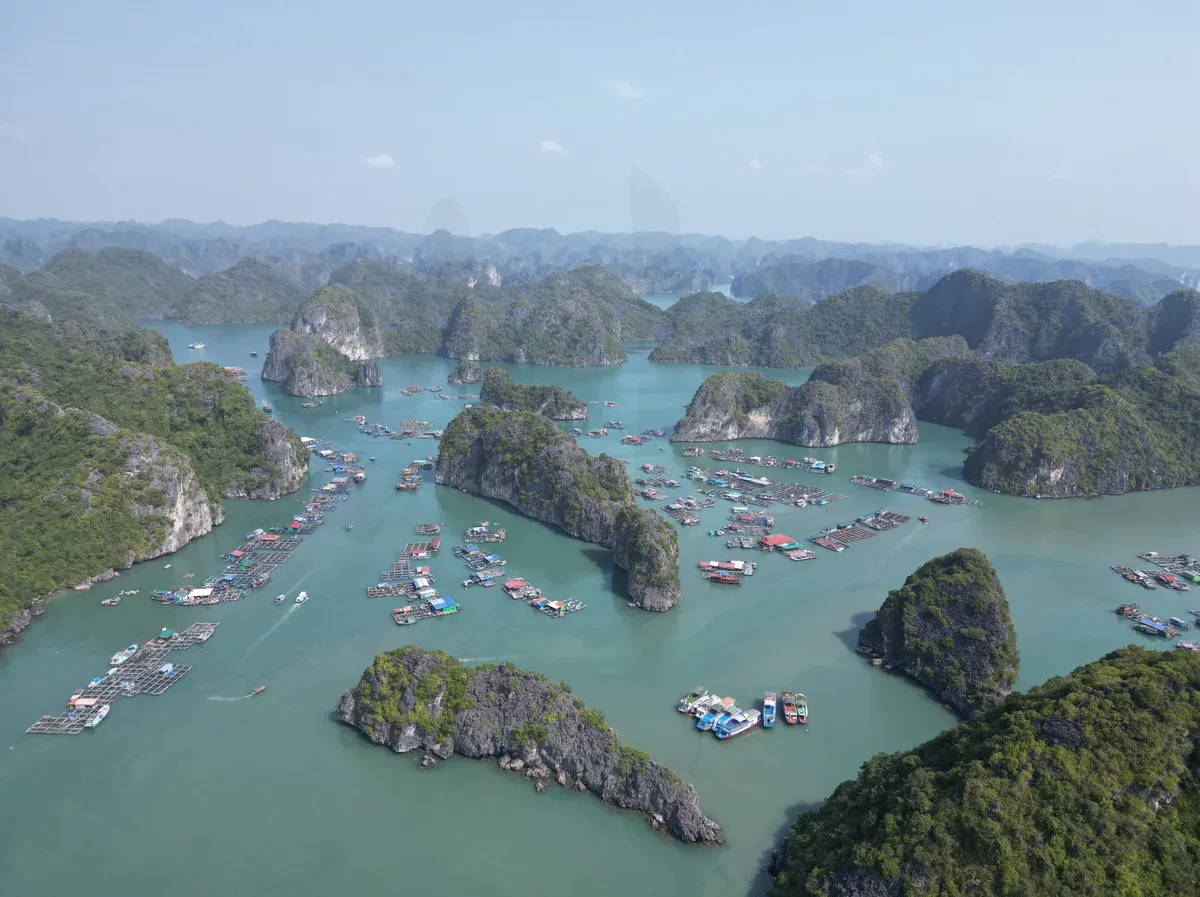 Aerial view of karst islands and floating fish farms in Lan Ha Bay near Cat Ba, Halong Bay cruise